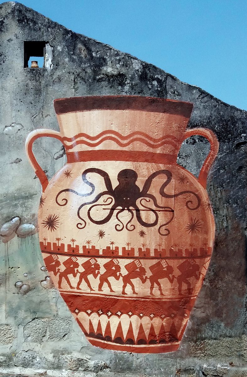 Close-up of a mural depicting a terracotta amphora decorated with a large octopus and a frieze of marching figures carrying loads, painted on a weathered stone wall with a small window opening above.