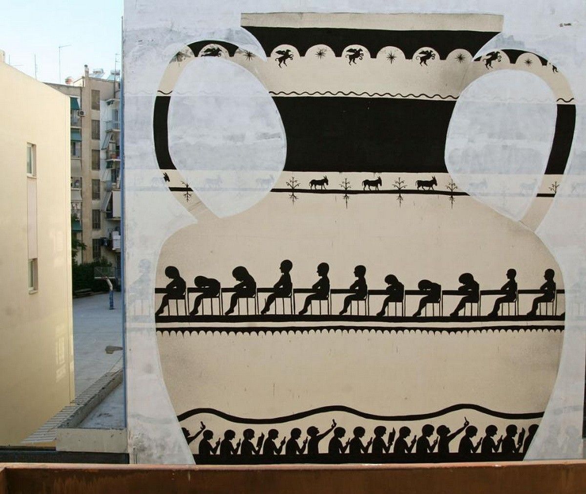 Closer view of the amphora mural's upper section, showing the two handle loops framed by a pegasus-and-star frieze, a row of donkeys, and the band of seated figures below.