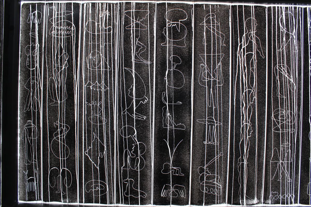 Wall of vertical ink drawings on paper backlit in a display case, showing abstract human figures and faces mixed with long straight vertical lines.