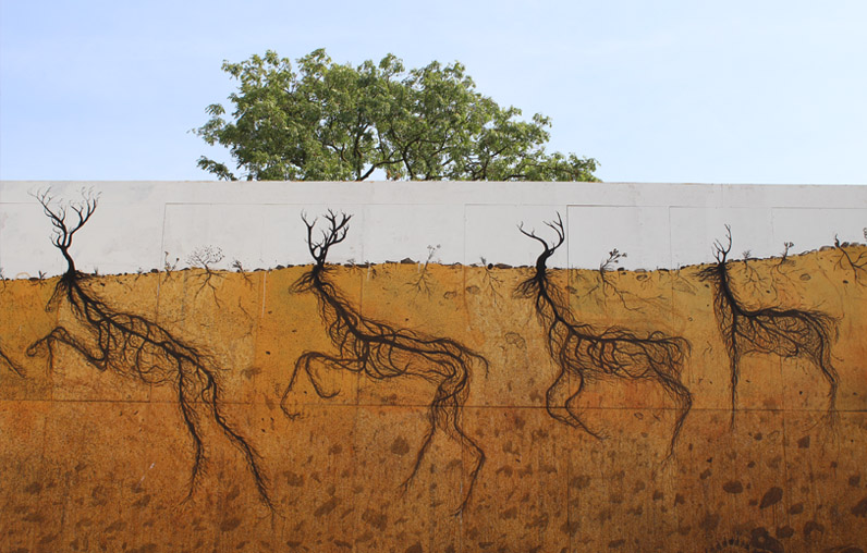 Four black wireframe deer made of root-like lines walking left across a wall, their antler-trunks reaching up into a white sky section and their bodies formed from roots spreading into the ochre earth band below.