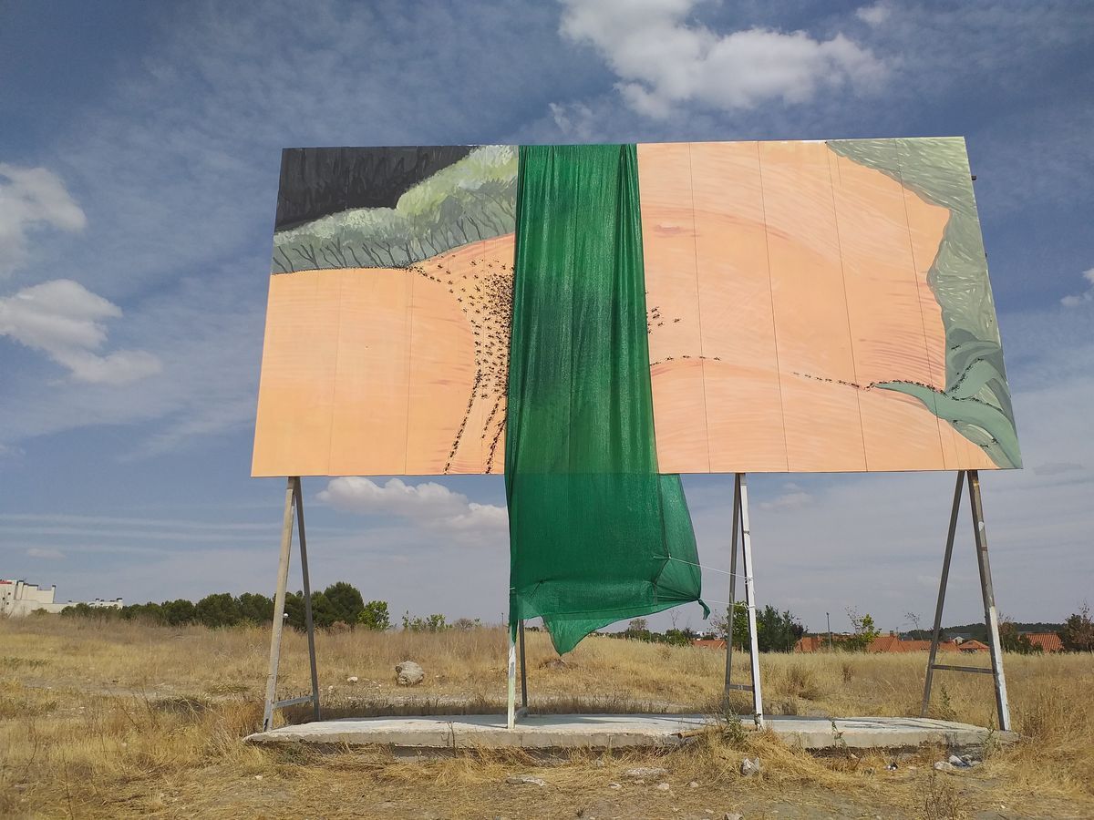 The same billboard, a homage to Courbet's L'Origine du monde, partially covered by a length of green mesh fabric draped down the center, splitting the painted scene of converging ants and green folds into two halves.