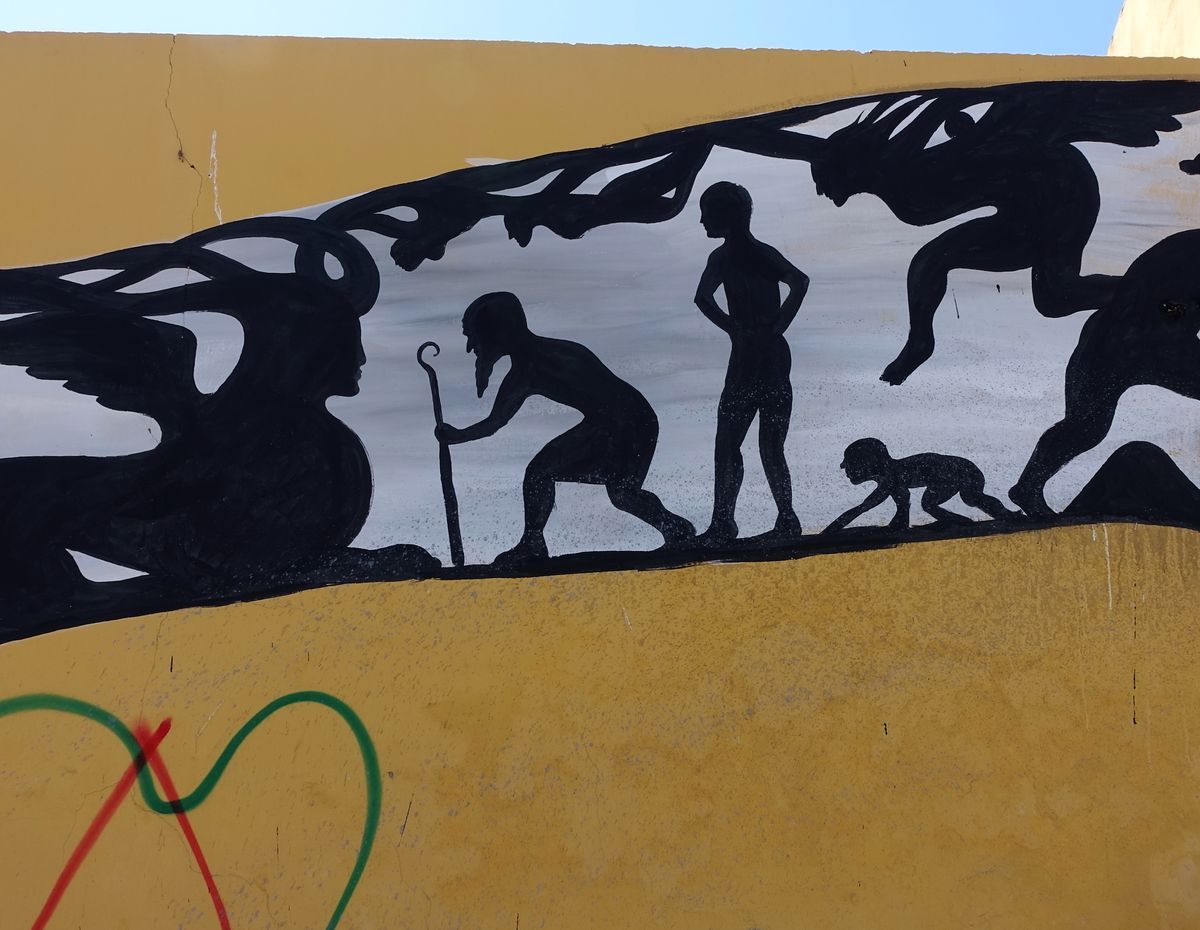Detail inside the snake's head showing silhouettes of an elderly bent figure with a walking stick, a standing figure, and a crawling baby, evoking an evolution-of-man motif.